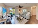 Bright living room features a comfortable seating area and a sliding glass door to outdoor space at 4057 Crockers Lake Blvd # 15, Sarasota, FL 34238