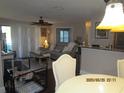 Open living room with neutral tones, slider to balcony and view of the dining area at 4057 Crockers Lake Blvd # 15, Sarasota, FL 34238