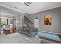 Comfortable living room featuring hardwood floors, a ceiling fan, and ample natural light at 412 E Amelia Ave, Tampa, FL 33602