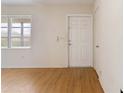 Bright entryway features wood-look flooring, a side window, and a white front door at 417 Glen Oak Rd, Venice, FL 34293