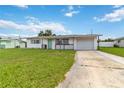 Inviting single-story home with a front lawn and private driveway leading to an attached garage at 417 Glen Oak Rd, Venice, FL 34293