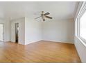 Spacious living room features wood-look flooring, a ceiling fan, and lots of natural light at 417 Glen Oak Rd, Venice, FL 34293