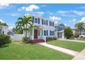 Beautiful two-story home with a well-manicured lawn, complemented by lush landscaping and a charming walkway at 480 28Th N Ave, St Petersburg, FL 33704