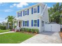 Inviting two-story home featuring lush greenery, complemented by a spacious driveway and crisp white fencing at 480 28Th N Ave, St Petersburg, FL 33704
