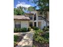 Inviting condo building exterior with well-maintained landscaping and visible unit numbers at 4835 Winslow Beacon # 46, Sarasota, FL 34235