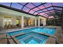 A screened-in pool with an attached spa provides a serene outdoor retreat at 4931 Benito Ct, Bradenton, FL 34211