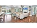Open living room with modern furnishings, a fireplace, and sliding doors to the pool area at 510 Wedge Ln, Longboat Key, FL 34228