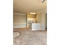 Cozy living room featuring neutral paint, breakfast bar, and tan carpet, perfect for relaxation and everyday living at 5146 Northridge Rd # 310, Sarasota, FL 34238