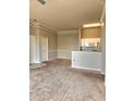 Inviting living room featuring plush carpet and a convenient breakfast bar to the kitchen with white cabinets and appliances at 5146 Northridge Rd # 310, Sarasota, FL 34238