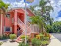 Beautiful coral condo with lush greenery and stairs, situated on a corner lot at 5500 Longwood Run Blvd # 203, Sarasota, FL 34243