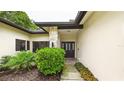 Charming home exterior featuring a stone pillar and an elegant front door at 6107 Misty Oaks St, Sarasota, FL 34243