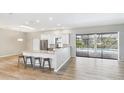 Open-concept kitchen with counter seating and views of the outdoor pool area at 6107 Misty Oaks St, Sarasota, FL 34243