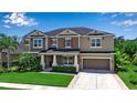 Charming two-story home boasts manicured landscaping, a two-car garage, and a welcoming front porch seating area at 6302 Anise Dr, Sarasota, FL 34238