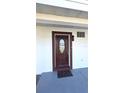 A close-up of the front door with decorative glass and a welcome mat at 6404 8Th Street W Ct, Bradenton, FL 34207
