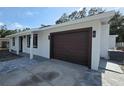 A single-story home with a modern one-car garage and a gray paver driveway at 6404 8Th Street W Ct, Bradenton, FL 34207