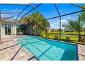 Screened-in pool with brick patio and view of the yard at 650 Rosemary Cir, Bradenton, FL 34212