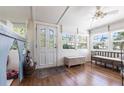 Bright foyer featuring hardwood floors, natural light from multiple windows, bench seating, and a decorative front door at 717 84Th Nw St, Bradenton, FL 34209