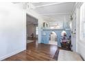 Hardwood floors meet a castle-themed playroom and an ornate storage bench in the home's entry area at 717 84Th Nw St, Bradenton, FL 34209