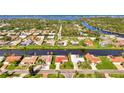 Aerial view of a waterfront community, highlighting the home's location on the water with lush surroundings at 74 Windsor Dr, Englewood, FL 34223