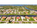 Aerial view of a waterfront community, highlighting the home's location on the water with lush surroundings at 74 Windsor Dr, Englewood, FL 34223