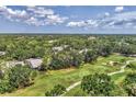 Picturesque aerial view showcasing the community, lush landscaping, golf course, and serene surroundings at 7617 Whitebridge Gln, University Park, FL 34201