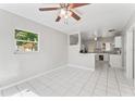 Bright living room with tiled floors, fan, and a view to the kitchen at 8075 48Th N Ave, St Petersburg, FL 33709
