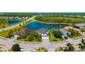 An aerial view of a home in a community with ponds and lush landscaping on an expansive lot at 826 Honeyflower Loop, Bradenton, FL 34212