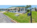 Well maintained house featuring a vibrant green lawn and tastefully decorated landscape at 830 Trento Dr, Venice, FL 34285