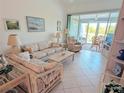 Bright living room with tile flooring, comfortable seating, and seamless access to the outdoor deck at 967 Waterside Ln # 1, Bradenton, FL 34209