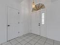 Entryway featuring tile flooring and a stylish front door with an arched transom window at 1026 Graham Rd, Venice, FL 34293