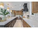 Gourmet kitchen showcasing custom cabinets, stone countertops, and stainless steel appliances at 128 Fillmore Dr, Sarasota, FL 34236