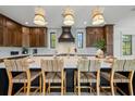 Spacious kitchen features a large island, bar seating, and modern lighting fixtures at 128 Fillmore Dr, Sarasota, FL 34236