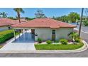 Charming single-story villa with a red tile roof, carport, and well-maintained landscaping at 139 Vista Hermosa Circle, Sarasota, FL 34242