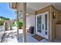 Inviting front entry featuring double glass doors, neutral paint, and a covered patio area at 139 Vista Hermosa Circle, Sarasota, FL 34242