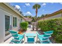 Cozy outdoor patio area with colorful Adirondack chairs, perfect for relaxing and enjoying the Florida sunshine at 139 Vista Hermosa Circle, Sarasota, FL 34242