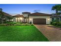 Beautiful single-story home with a well-manicured lawn, paver driveway, and a two-car garage at 15315 Derna Ter, Bradenton, FL 34211