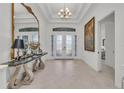 Spacious foyer featuring high ceilings, a decorative mirror, and tiled flooring at 15315 Derna Ter, Bradenton, FL 34211