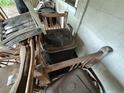A jumbled collection of worn-out chairs, an aging air conditioning unit, and discarded items at 2230 50Th N Ave, St Petersburg, FL 33714