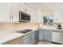 Bright kitchen featuring quartz countertops, stainless steel appliances, and under cabinet lighting at 2310 Gulf N Dr # 104, Bradenton Beach, FL 34217