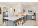 Modern kitchen with stainless steel appliances, stylish countertops, and convenient breakfast bar at 2310 Gulf N Dr # 104, Bradenton Beach, FL 34217