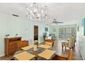 This light and airy dining room features tile floors and a modern chandelier at 2639 Woodgate Ln # H8, Sarasota, FL 34231