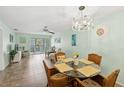 Inviting dining room featuring a glass table, wicker chairs, and a stylish light fixture at 2639 Woodgate Ln # H8, Sarasota, FL 34231