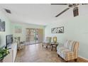 Inviting living room featuring tile floors, comfortable seating, and sliding glass doors to a balcony at 2639 Woodgate Ln # H8, Sarasota, FL 34231