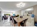 Dining room area with neutral walls, ceiling fan, a mirror, and tile floors at 2763 Woodgate Ln # 211, Sarasota, FL 34231