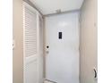 Interior view of the front door with white door and closet, neutral paint, and white trim at 2763 Woodgate Ln # 211, Sarasota, FL 34231