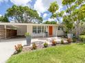 Inviting front porch with bright orange door and seating area perfect for relaxing at 2933 Michigan St, Sarasota, FL 34237