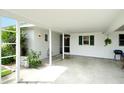 Spacious carport featuring white support beams and room for outdoor seating at 3276 Westford Ln, #117,, Sarasota, FL 34231