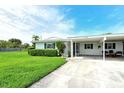 Inviting single-story home with lush green lawn and convenient covered parking at 3276 Westford Ln, #117,, Sarasota, FL 34231