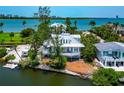 Aerial view of beautiful waterfront home surrounded by tropical landscaping, near the beach at 3737 Bayou Louise Ln, Sarasota, FL 34242