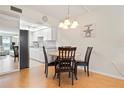 Cozy dining area featuring a chandelier and seating for four, next to kitchen at 3802 Gulf Of Mexico Dr # A205, Longboat Key, FL 34228